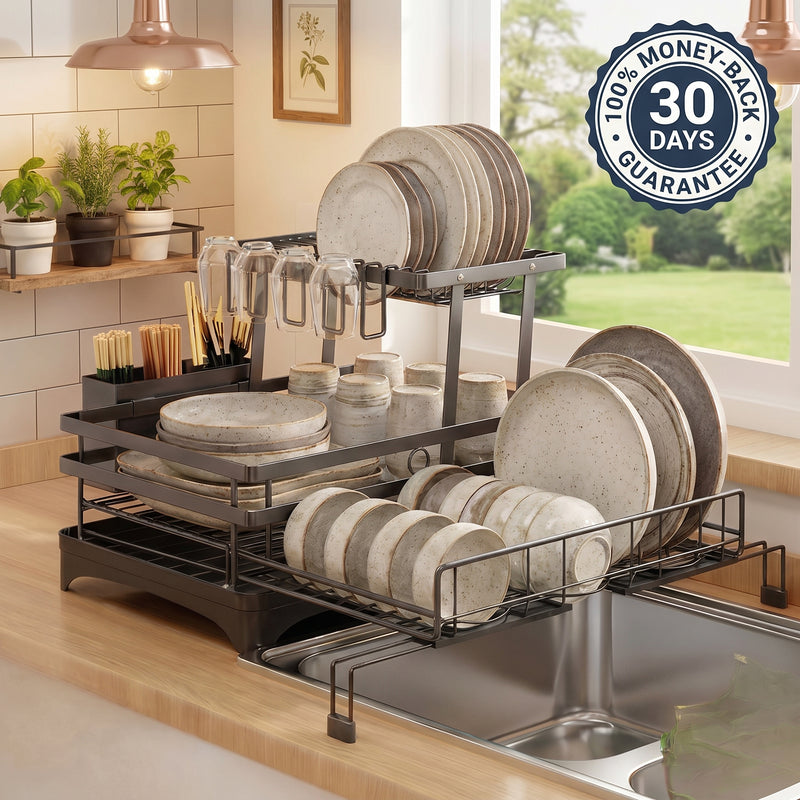 A black metal dish rack set on a kitchen counter, holding plates, bowls, and cups. The background shows a bright kitchen with plants, a window, and a '100% MONEY-BACK 30 DAYS GUARANTEE' badge overlay.